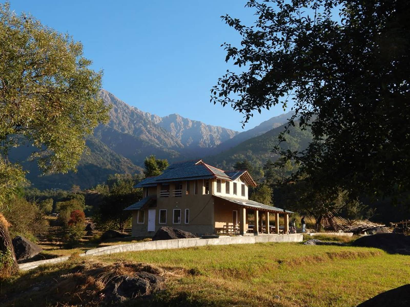The Earth House overlooking Dhauladhar Mountain Range